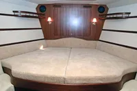 Luxurious cabin interior of 2007 Motorsailer ВС-1800С with wood paneling and cozy bedding.