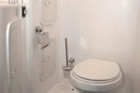 Compact bathroom in 2007 Motorsailer ВС-1800С, featuring a white marine toilet and storage compartments.