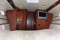 Luxurious cabin interior of 2007 Motorsailer ВС-1800С with wood paneling and mounted TV.