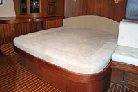 Luxurious cabin interior of 2007 Motorsailer ВС-1800С with wooden finishes and cozy bed.