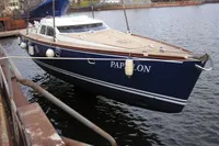 2007 Motorsailer ВС-1800С docked, blue hull, named "PAPILON," in a harbor setting.