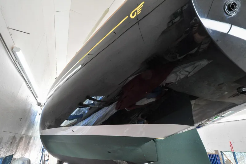 Night Train Yacht Photos Pics Hinckley Sou'wester 51 yacht, 1986 model, sleek black hull in a workshop setting.