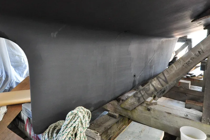 Night Train Yacht Photos Pics 1986 Hinckley Sou'wester 51 yacht keel in dry dock, supported by wooden beams.