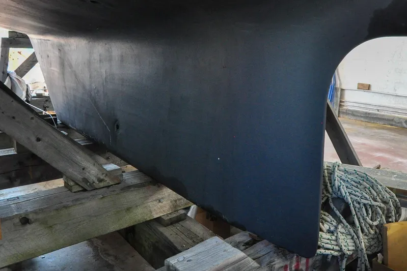 Night Train Yacht Photos Pics 1986 Hinckley Sou'wester 51 sailboat hull on wooden supports in a workshop.