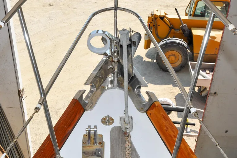 Night Train Yacht Photos Pics Bow of 1986 Hinckley Sou'wester 51 sailboat with anchor, in a shipyard setting.