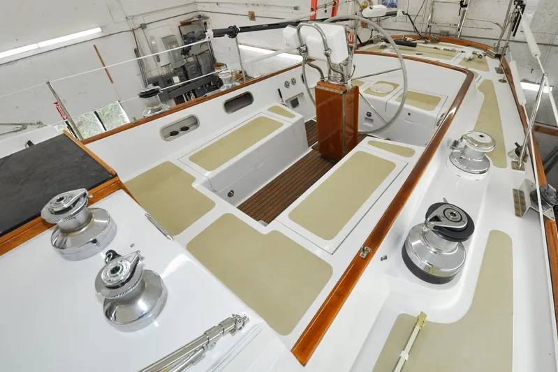 Night Train Yacht Photos Pics 1986 Hinckley Sou'wester 51 sailboat cockpit with winches and steering wheel in a workshop.