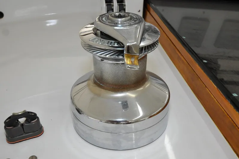 Night Train Yacht Photos Pics Chrome winch on 1986 Hinckley Sou'wester 51 sailboat deck, showcasing nautical equipment.