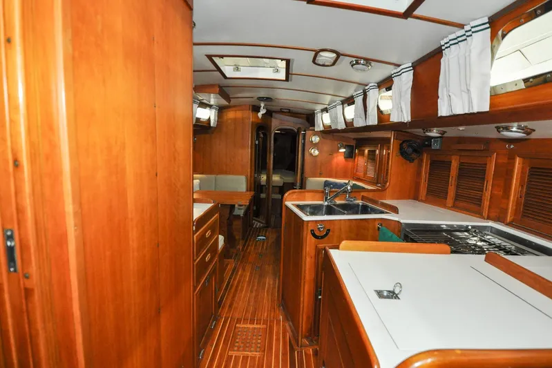 Night Train Yacht Photos Pics Interior of 1986 Hinckley Sou'wester 51 yacht with wooden cabinetry and modern amenities.