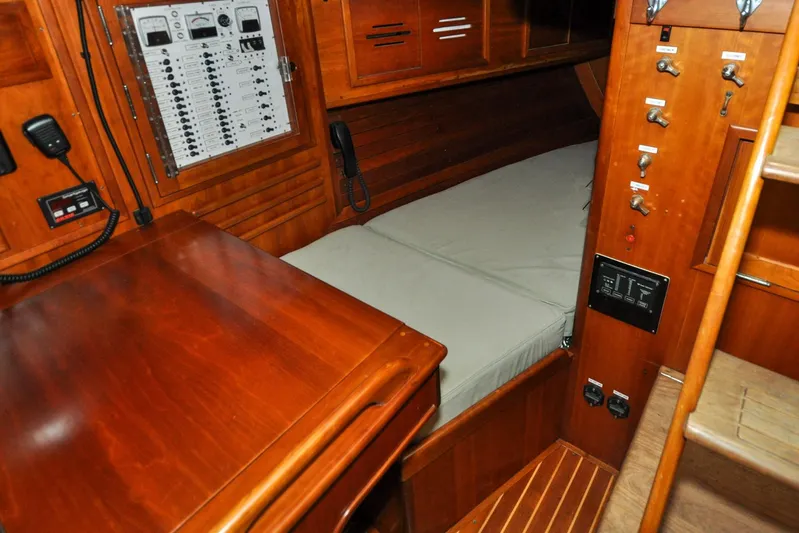 Night Train Yacht Photos Pics Interior of 1986 Hinckley Sou'wester 51 sailboat with wooden cabinetry and control panel.