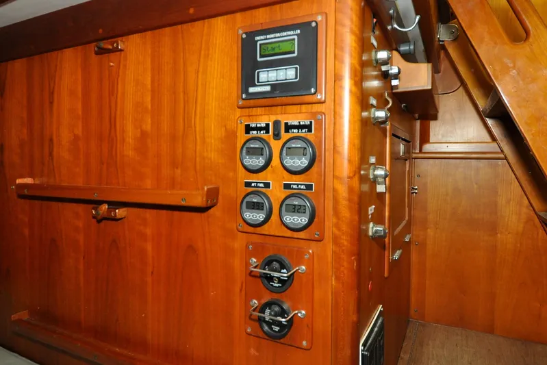 Night Train Yacht Photos Pics Hinckley Sou'wester 51 yacht interior control panel, 1986 model, featuring wooden cabinetry and gauges.