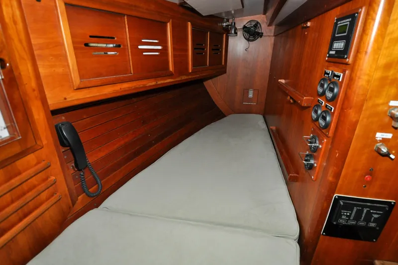 Night Train Yacht Photos Pics 1986 Hinckley Sou'wester 51 yacht interior with wooden cabinetry and control panels.