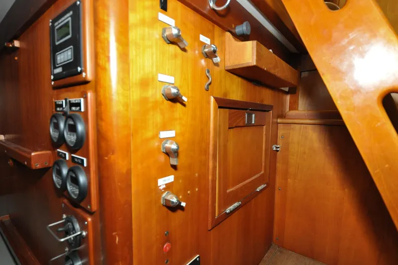 Night Train Yacht Photos Pics Interior of 1986 Hinckley Sou'wester 51 yacht, featuring wooden cabinetry and control panels.