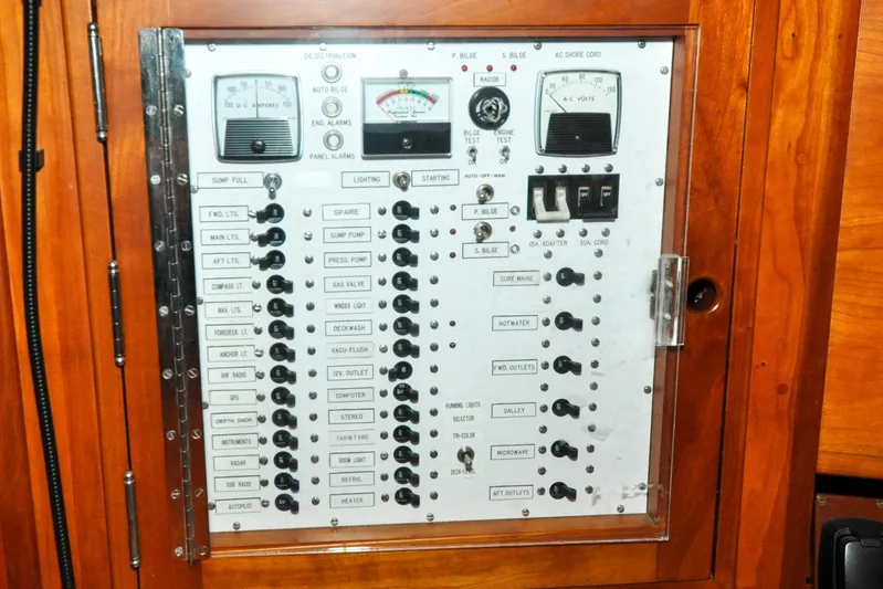Night Train Yacht Photos Pics Electrical control panel on a 1986 Hinckley Sou'wester 51 sailboat, featuring switches and gauges.