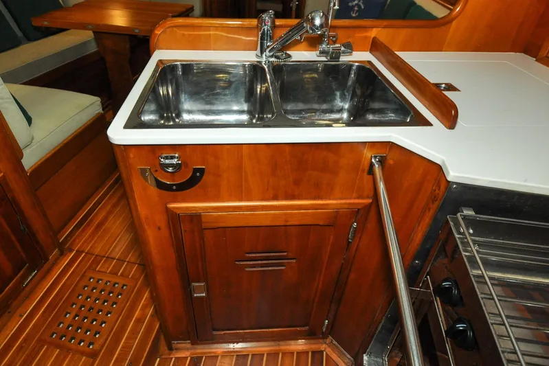 Night Train Yacht Photos Pics Hinckley Sou'wester 51 yacht kitchen with wooden cabinetry and stainless steel sink, 1986 model.