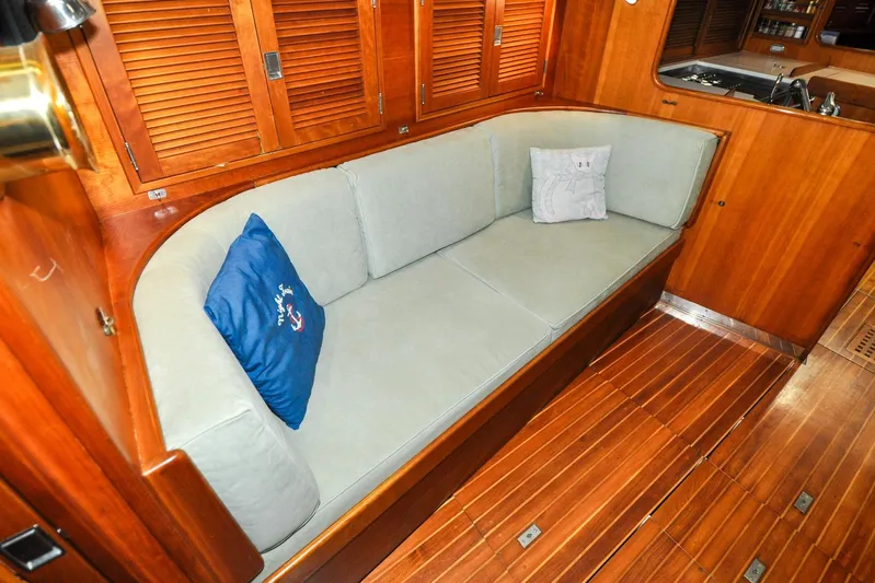 Night Train Yacht Photos Pics Luxurious interior of 1986 Hinckley Sou'wester 51 yacht with wooden finish and cozy seating.