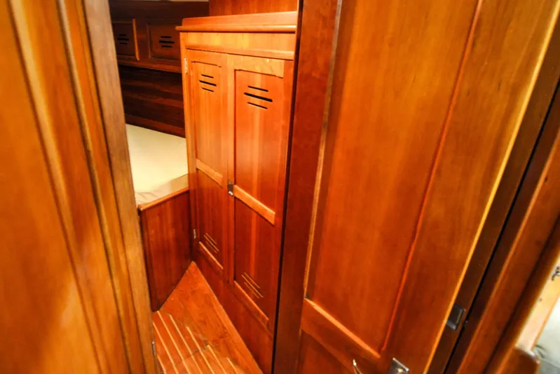 Night Train Yacht Photos Pics Hinckley Sou'wester 51 yacht interior, 1986, featuring wooden cabinetry and cozy sleeping quarters.