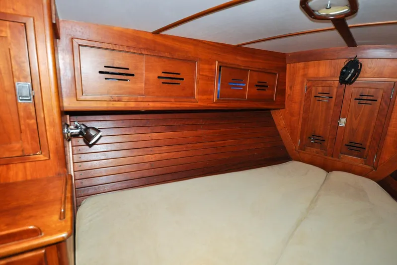 Night Train Yacht Photos Pics Hinckley Sou'wester 51 (1986) cabin interior with wooden paneling and cozy bed.