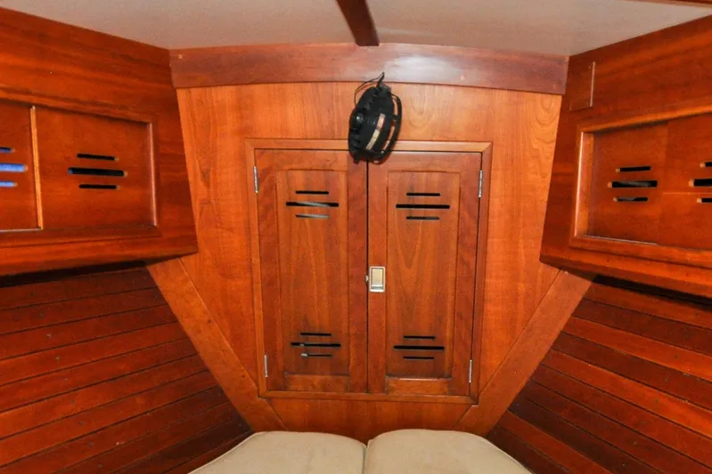 Night Train Yacht Photos Pics Interior of 1986 Hinckley Sou'wester 51 sailboat with wooden cabinetry and cozy berth.