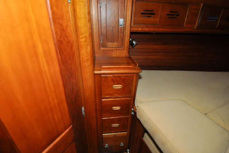 Night Train Yacht Photos Pics Hinckley Sou'wester 51 yacht interior, 1986, featuring wooden cabinetry and cozy sleeping area.