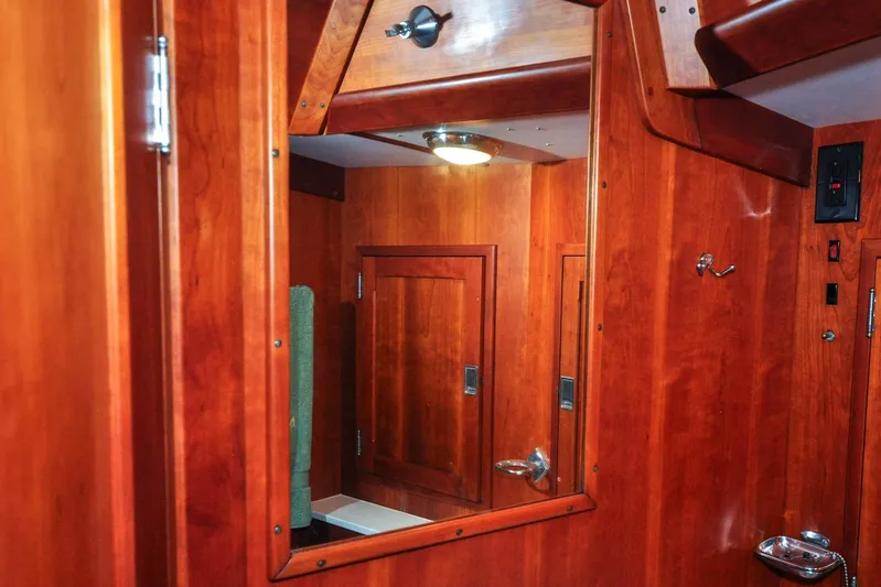 Night Train Yacht Photos Pics Interior of 1986 Hinckley Sou'wester 51 yacht with polished wood finish and mirror.