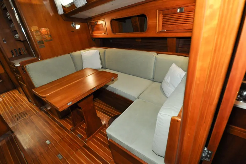 Night Train Yacht Photos Pics Luxurious wooden interior of 1986 Hinckley Sou'wester 51 yacht with cozy seating area.