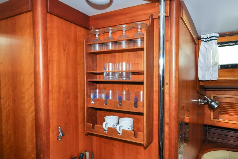 Night Train Yacht Photos Pics Wooden interior of 1986 Hinckley Sou'wester 51 yacht with glass and mug storage.