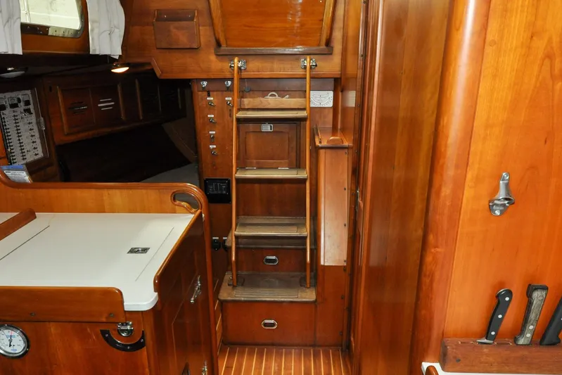 Night Train Yacht Photos Pics Interior of 1986 Hinckley Sou'wester 51 sailboat with wooden cabinetry and ladder.