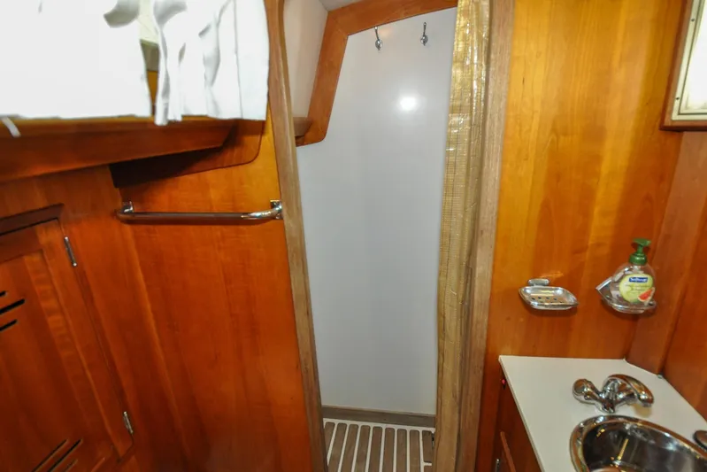 Night Train Yacht Photos Pics Hinckley Sou'wester 51 yacht bathroom, 1986 model, featuring wooden cabinetry and compact sink.
