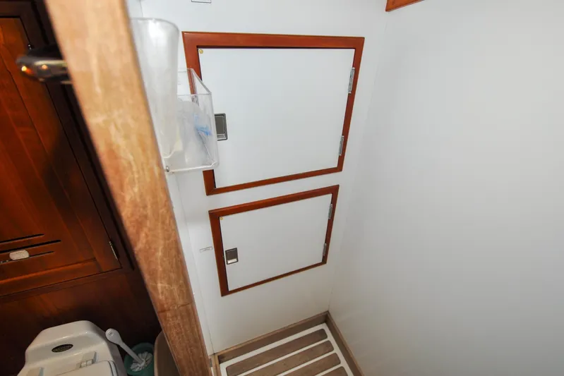 Night Train Yacht Photos Pics Interior of 1986 Hinckley Sou'wester 51 yacht, featuring wooden cabinetry and storage compartments.