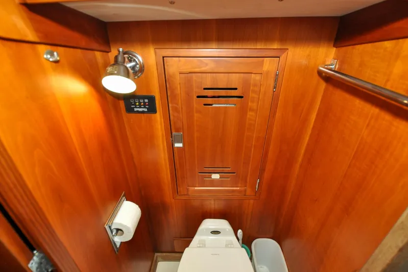 Night Train Yacht Photos Pics Hinckley Sou'wester 51 yacht bathroom, 1986, featuring wooden cabinetry and modern fixtures.