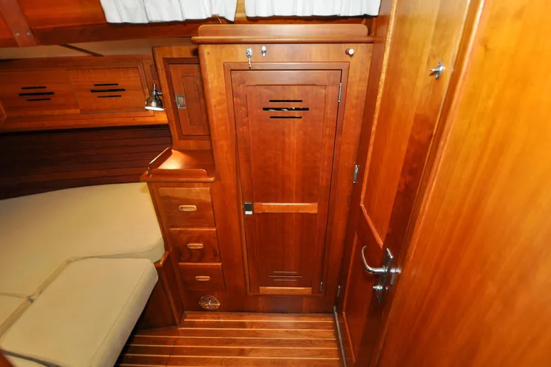 Night Train Yacht Photos Pics Hinckley Sou'wester 51 (1986) interior with wooden cabinetry and cozy sleeping area.