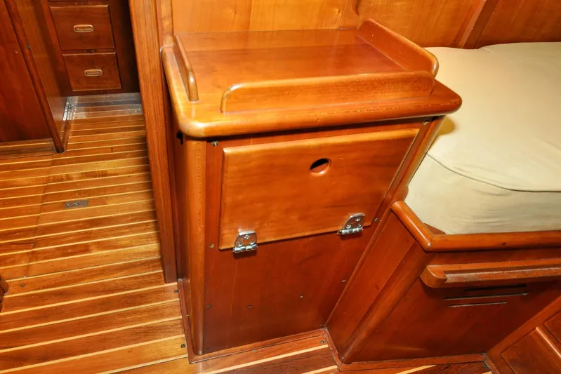 Night Train Yacht Photos Pics Wooden interior of 1986 Hinckley Sou'wester 51 yacht, featuring polished cabinetry and flooring.