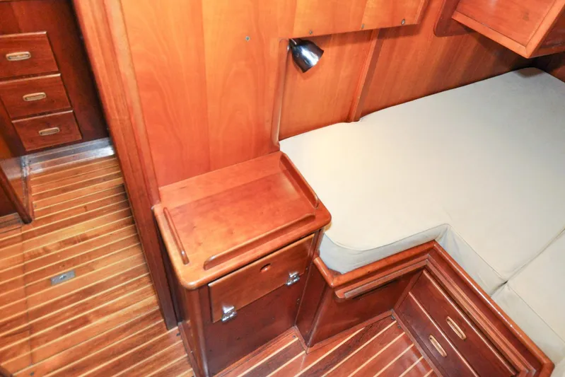 Night Train Yacht Photos Pics Hinckley Sou'wester 51 (1986) cabin interior with wooden cabinetry and flooring.