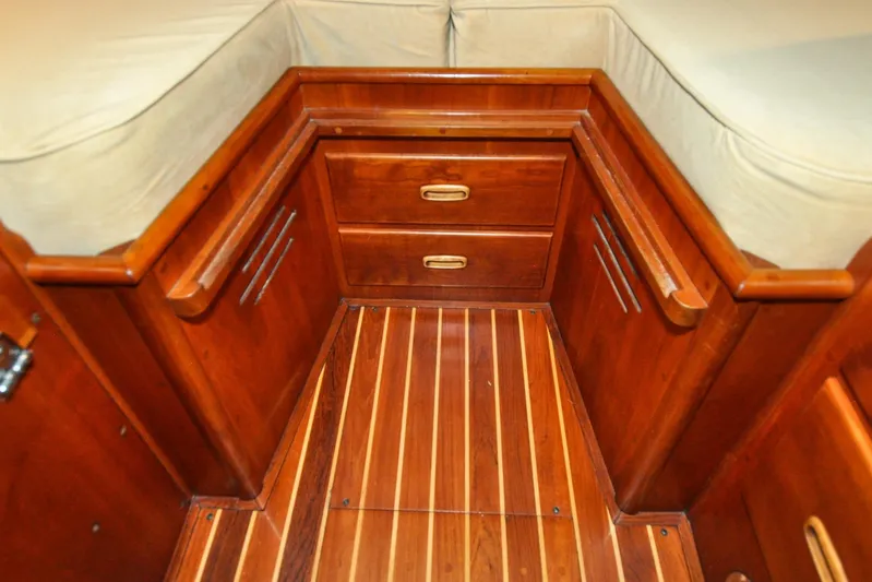 Night Train Yacht Photos Pics Hinckley Sou'wester 51 (1986) interior with wooden cabinetry and striped flooring.