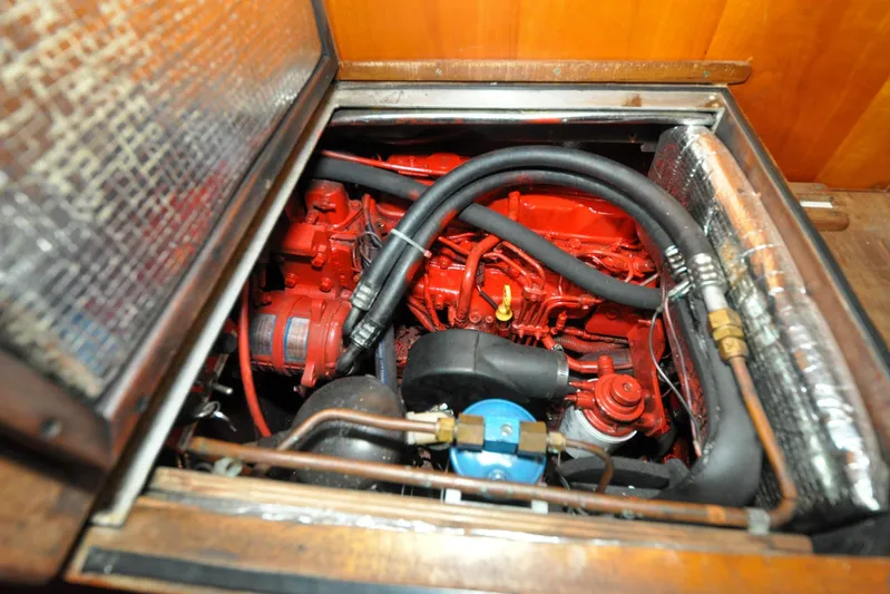 Night Train Yacht Photos Pics Engine compartment of a 1986 Hinckley Sou'wester 51 sailboat, featuring red engine components.