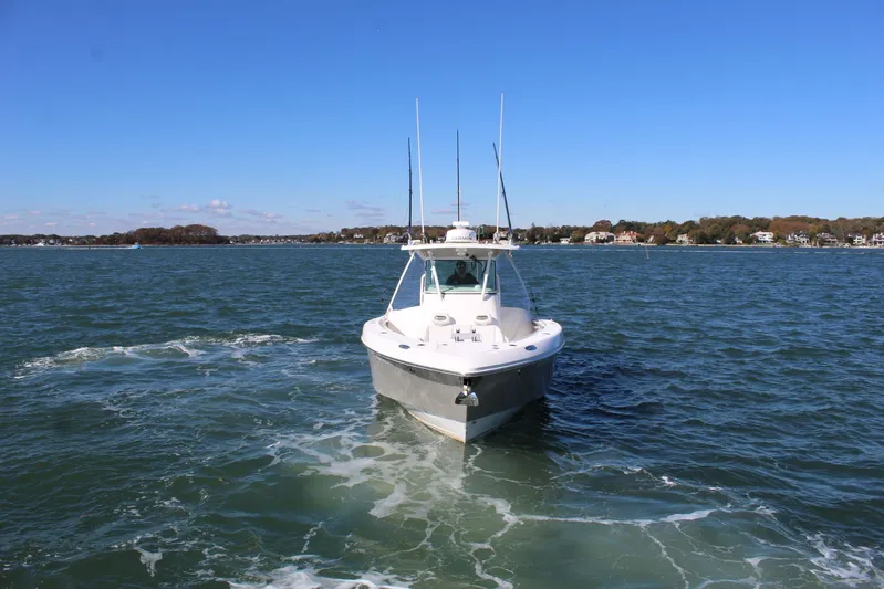 Reel Heavy Yacht Photos Pics 2009 Everglades 320 Center Console boat cruising on a sunny day.