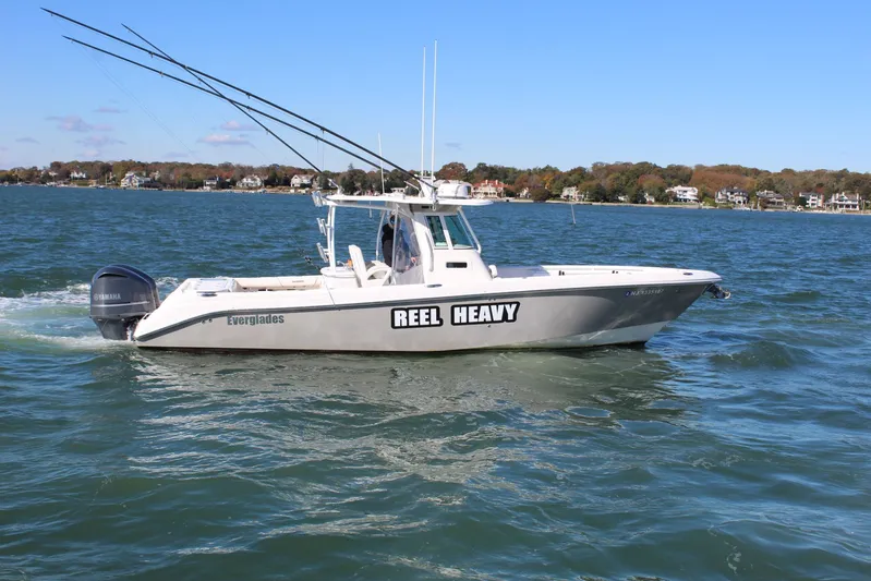 Reel Heavy Yacht Photos Pics 2009 Everglades 320 Center Console boat cruising on a sunny day.
