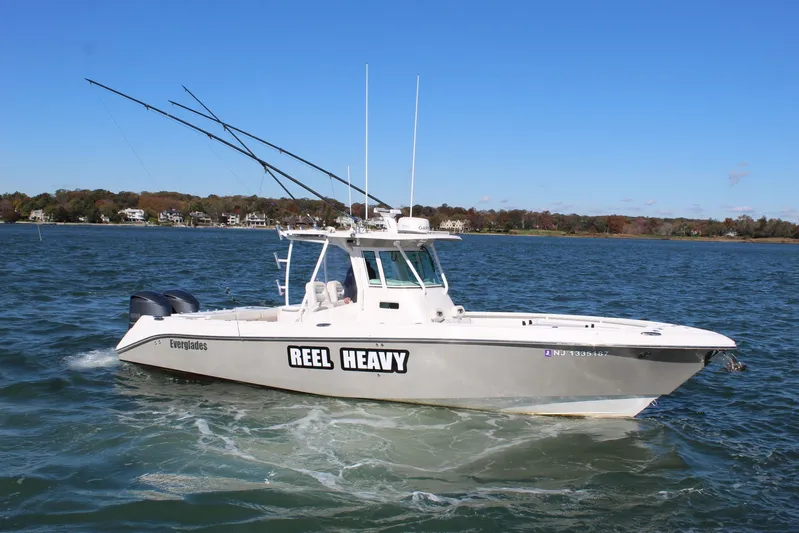 Reel Heavy Yacht Photos Pics 2009 Everglades 320 Center Console boat on water, clear sky, distant shoreline.