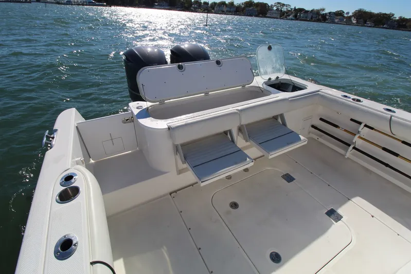 Reel Heavy Yacht Photos Pics 2009 Everglades 320 Center Console boat interior with seating and storage, on water.