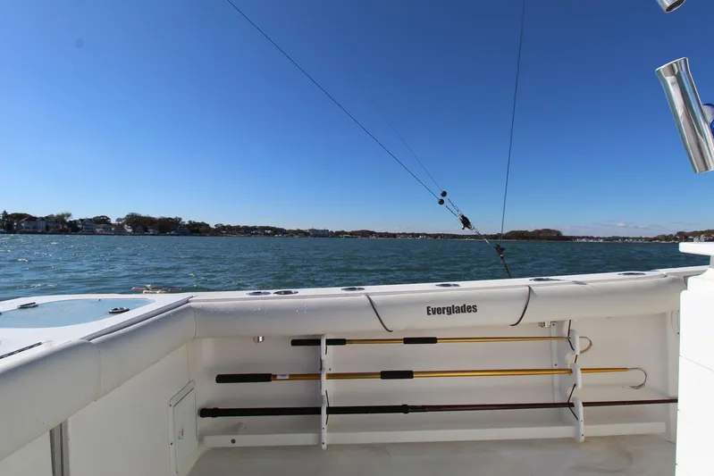 Reel Heavy Yacht Photos Pics 2009 Everglades 320 Center Console boat on water, clear sky, fishing rods visible.