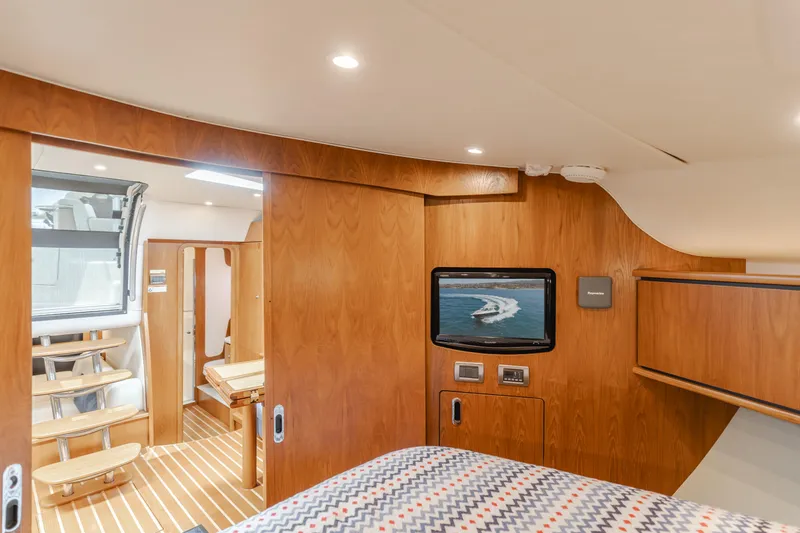 Worked The Plan Yacht Photos Pics 2009 Tiara Yachts 3900 Sovran interior with wood paneling, TV, and cozy cabin space.