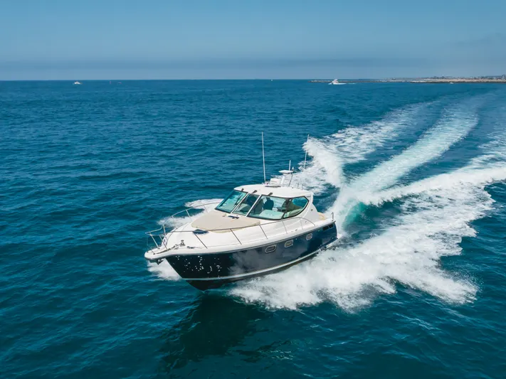 Worked The Plan Yacht Photos Pics 2009 Tiara Yachts 3900 Sovran cruising on open blue ocean waters.