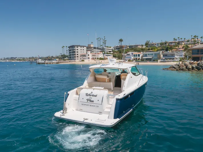 Worked The Plan Yacht Photos Pics 2009 Tiara Yachts 3900 Sovran cruising near Newport Beach, clear blue water, sunny day.