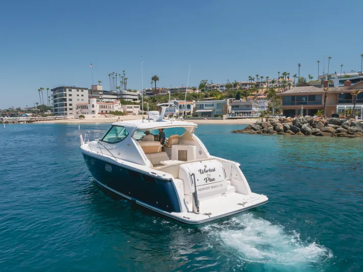 Worked The Plan Yacht Photos Pics 2009 Tiara Yachts 3900 Sovran cruising near a scenic coastal town.