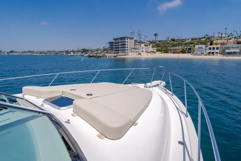 Worked The Plan Yacht Photos Pics 2009 Tiara Yachts 3900 Sovran cruising near a scenic coastal shoreline.