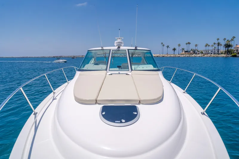 Worked The Plan Yacht Photos Pics 2009 Tiara Yachts 3900 Sovran on clear blue water, sunny day, palm trees in background.