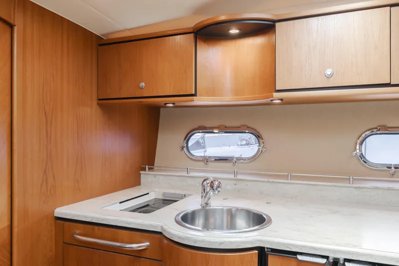 Worked The Plan Yacht Photos Pics 2009 Tiara Yachts 3900 Sovran kitchen with wood cabinets and stainless steel sink.