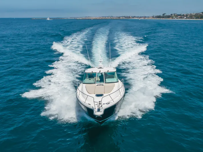 Worked The Plan Yacht Photos Pics 2009 Tiara Yachts 3900 Sovran cruising on open water, leaving a wake behind.