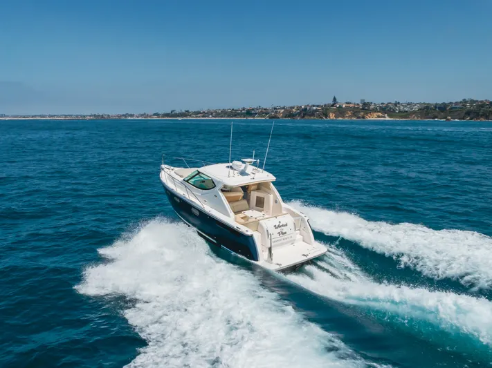 Worked The Plan Yacht Photos Pics 2009 Tiara Yachts 3900 Sovran cruising on open water near coastline.