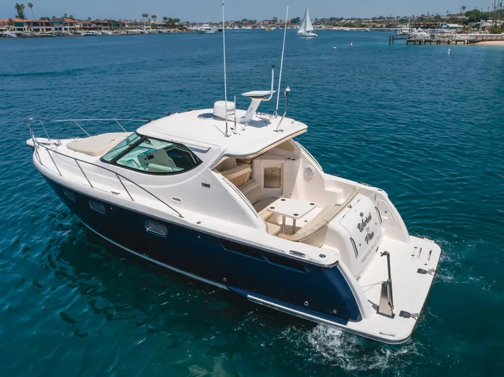 Worked The Plan Yacht Photos Pics 2009 Tiara Yachts 3900 Sovran cruising in a scenic harbor setting.